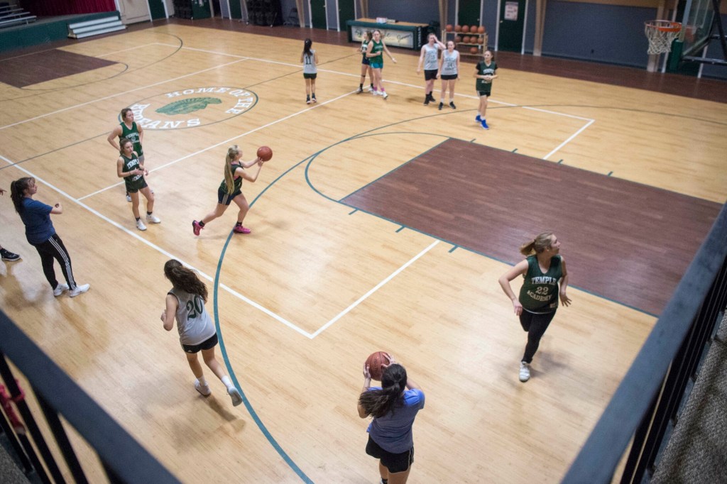 The Temple Academy girls basketball team practices at Temple Academy in Waterville on Friday. The team includes students from nine countries, including the United States, and is headed for the tournament with a record of 14-4.