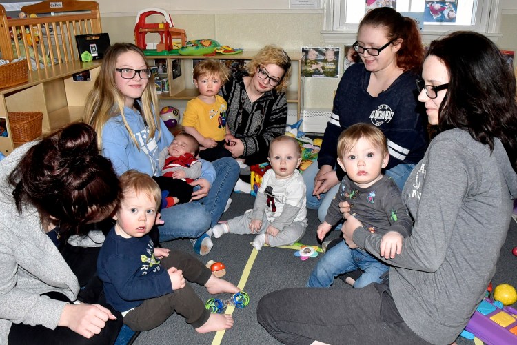 Teen mothers play with their children during a break in classes at the Sharon Abrams Teen Parent program at the Maine Children's Home for Little Wanderers in Waterville  Monday. The program receives funding through the United Way of Mid-Maine.