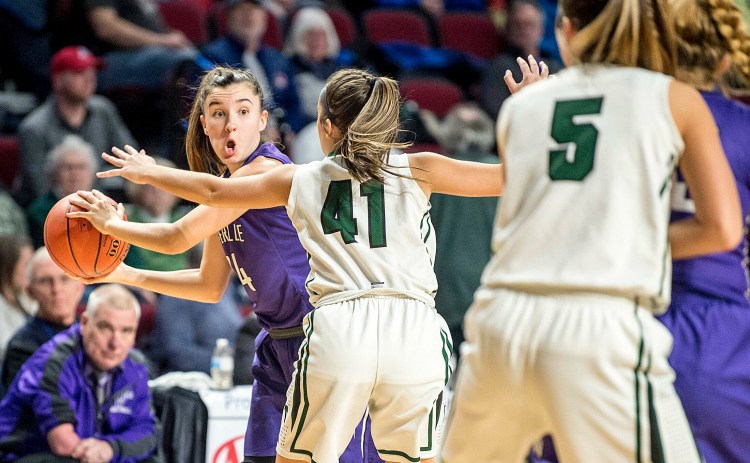 Waterville's Sadie Garling (24) looks to pass the ball as Mt. Desert Island defender Hannah Chamberlain closes in during the second half of the Class B North championship game last season at the Cross Insurance Center in Bangor.