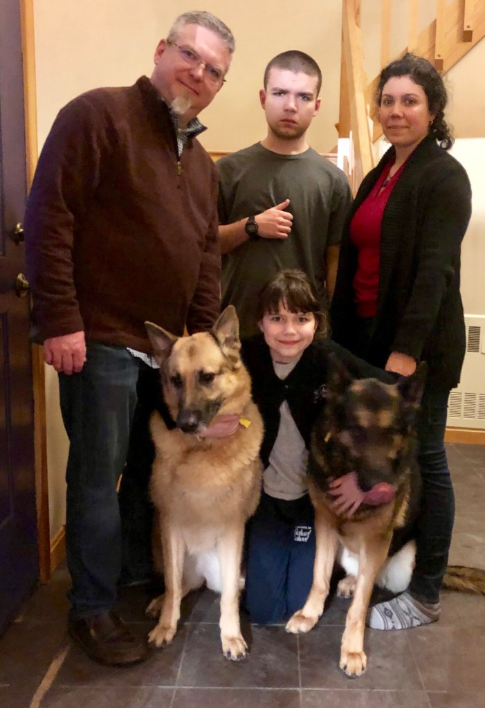 The Reight family poses with their two German Shepherds, Anani and Luna. Anani fell through ice on Belgrade Stream and was rescued by Readfield Fire Department, which had just received ice water rescue suits that day. Standing are, from left, Dr. Ian Reight, Julian Reight and Jeanett Reight; and, kneeling, Amalia Reight.