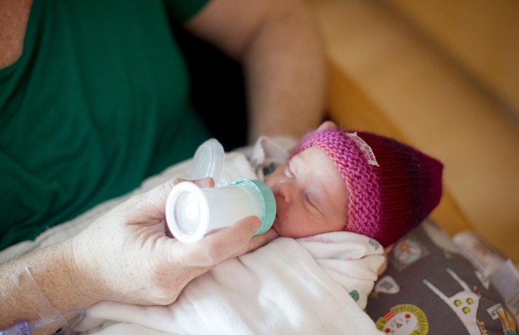 Melanie Lord feeds her newborn daughter, Lila, pasteurized breastmilk at Maine Medical Center on March 20. The hospital now gives pasteurized breastmilk from donors to some babies in their first four days of life. The milk comes from the Mothers' Milk Bank Northeast, a Massachusetts-based nonprofit that accepts donated milk and distributes it to hospitals.
