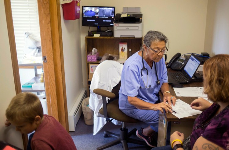 Nurse practitioner   Priscilla Perry meets with a patient in her office at the Machias branch of Maine Family Planning in 2017. The organization is seeking state funds to replace $2 million in federal funding that Maine Family Planning declined because it would have restricted the information it could give to patients.  