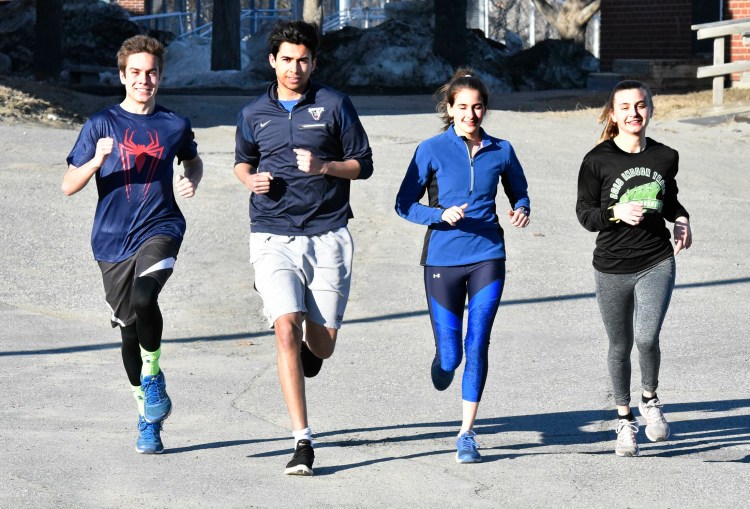Messalonskee High School runners, from left, Hunter Smart, Sami Benayad, Sarah Kohl and Peyton Arbour run in Oakland on the first day of practice Monday.