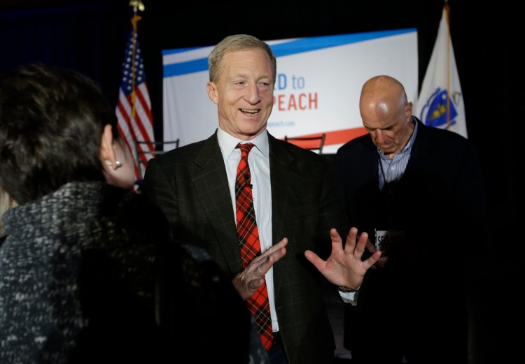 Billionaire investor and Democratic activist Tom Steyer, center, greets people in the audience at the conclusion of a "Need to Impeach" town hall event on March 13 in Agawam, Mass. Steyer claims that President Trump meets the criteria for impeachment. He is expected to announce his candidacy for president, according to reports.