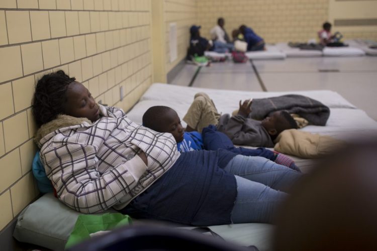 A mother and son sleep on mats at the Salvation Army gym in Portland in December.