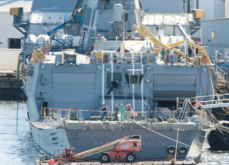 Workers walk across the aft deck of an Arleigh Burke destroyer at Bath Iron Works in 2016. The yard was praised for its workforce development efforts by U.S. Navy Secretary Richard Spencer in a recent congressional committee hearing. 