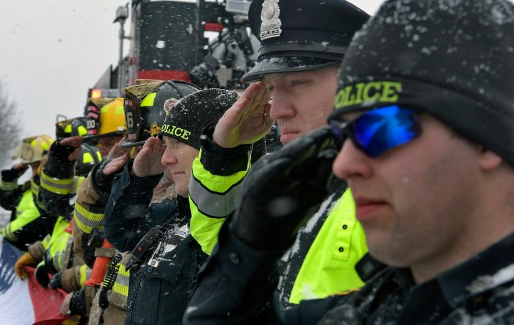 Monday's snow didn't deter Augusta police and firefighters from saluting the remains of Maine State Police Det. Benjamin Campbell, which were being escorted through Augusta to Portland for his funeral on Tuesday. Firefighters unfurled a 12-foot-long American flag on the side of Belgrade Road overpass on Interstate 95 as troopers passed by.