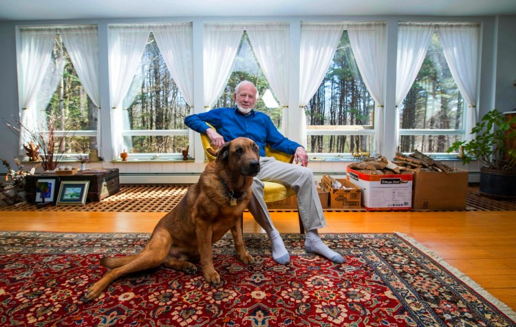 Fred Wiand poses Tuesday with his dog, Baxter, at his home in South China. Wiand has filed papers to run for president of the United States as a Democrat in the 2020 election. 