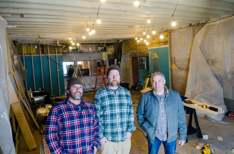 From left, co-owners Matthew Kendall, Steve Sommers and Steve Casey pose on Wednesday in what will become the brew room of Bateau Brewing  in Gardiner.