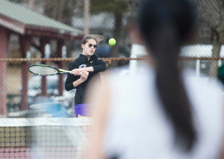 Waterville's Inga Zimba, facing, returns a shot from Kents Hills singles player Rina Akasaka during a preseason match at the North Street courts in Waterville.
