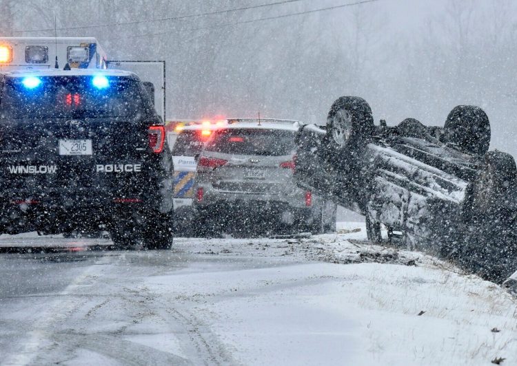 A vehicle rolled over on the snow-covered Route 137, also called China Road, in Winslow on Monday.