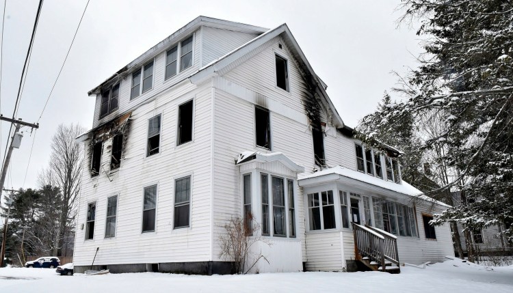 The burned apartment building at 378 Water St. in Skowhegan is on Tuesday. Authorities said a fire at the building last week was sparked after siding blew off, hit utility wires and triggered electricity surges inside. 