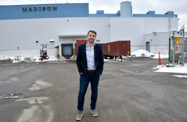 Josh Henry, co-founder and president of Belfast-based GO Lab Inc., stands in front of the shuttered former paper mill in Madison in April 2019. GO Lab announced Thursday that it has secured the $85 million in financing it needs to move forward with constructing a wood-fiber insulation manufacturing plant at the former mill. The new operation will employ about 120 people, with more to be added later, the company said.