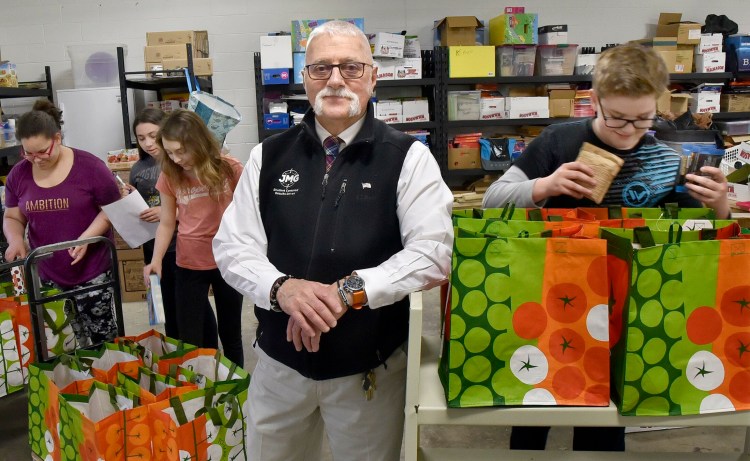 Victor Esposito, a Jobs for Maine Graduates specialist, works with JMG students Friday at Vassalboro Community School in an in-school food pantry project. He has been named 2018 Mid-Maine Chamber of Commerce's Outstanding Professional. 