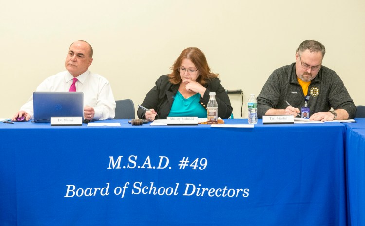 Reza Namin, superintendent of MSAD 49, left, Shelley Rudnicki, school board chair, center, and Tim Martin, vice chair, right,  listen to school board member Kara Kugelmeyer voice her concerns about changes in legal counsel during a board meeting at Lawrence Junior High School in Fairfield on Thursday.
