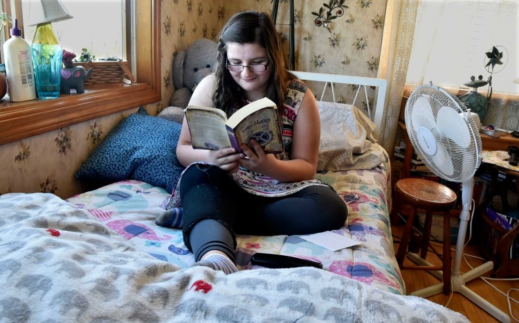 Cierrah French, 12, sitting on her bed on Wednesday in her grandparents Alicia and Wayne Blodgett’s home in Skowhegan on Wednesday, is a voracious reader. Cierrah will undergo surgery in Boston on Tuesday for cancer in her leg.
