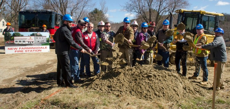 Town officials, firefighters, donors and contractors toss dirt Wednesday during a ceremonial groundbreaking for a new Farmingdale fire on Maine Avenue in Farmingdale.
