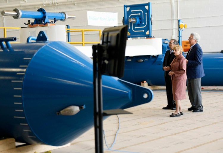 Gov. Janet Mills gets a tour of Ocean Renewable Power Co.'s RivGen Power System at Brunswick Landing in April. Giving the tour are company executives John Ferland, left, and Christopher Sauer. The company was celebrating the commercial launch of the system, which generates electricity from submerged turbines in rivers. 