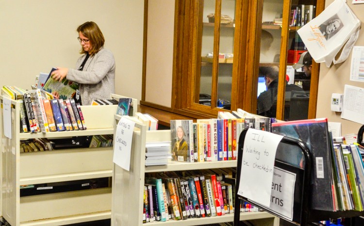 Librarian Kellie Dudley sorts books onto carts Thursday at Lithgow Public Library in Augusta so they can be scanned back in after the circulation computer system is fixed.