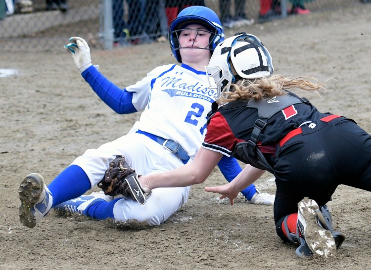 Hall-Dale's Iris Ireland can't get the tag at home on Madison's Landyn Landry when the ball gets loose during a Mountain Valley Conference game Tuesday in Farmingdale.   