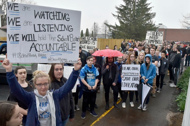 Lawrence High School students, including student Marian Zawistowski, left, and an estimated 300 other students from all grades, assemble Wednesday outside the School Administrative District 49 superintendent's office in Fairfield in a silent protest regarding restructuring that led to the resignation of Principal Mark Campbell.