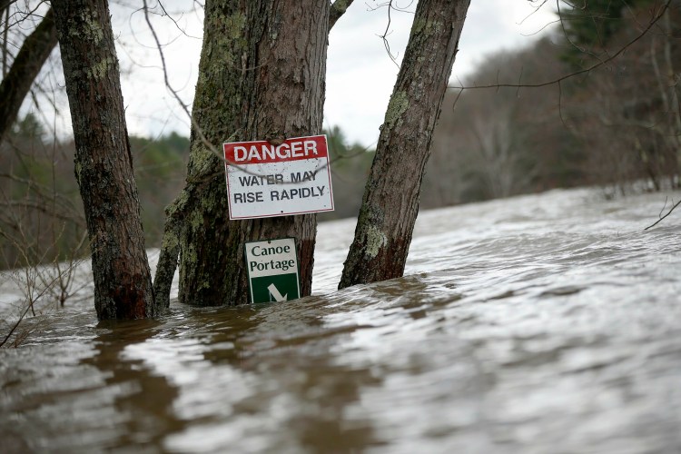 Water floods the canoe portage directly below the Saco River Reservoir near River Road in West Buxton on Wednesday.