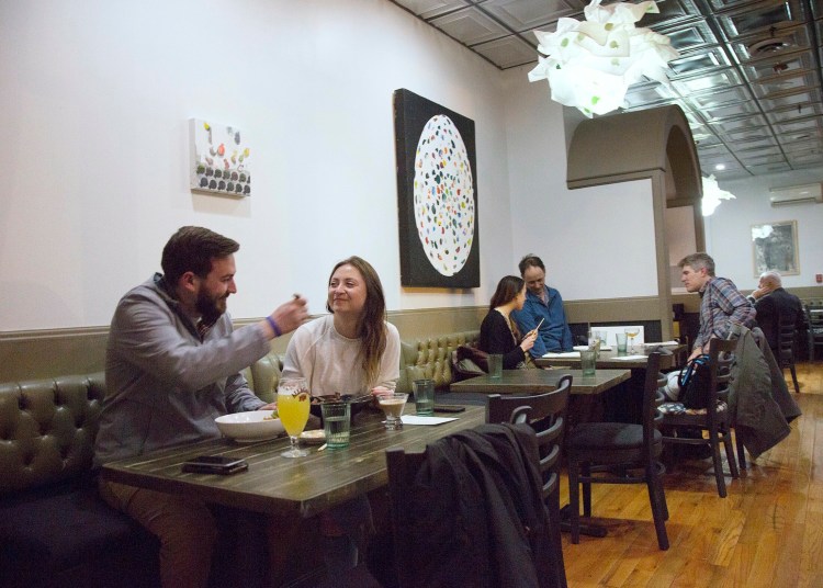 Tyler Rocheleau and Nicole DeMedio, both of South Portland, dine upstairs at N to Tail. 