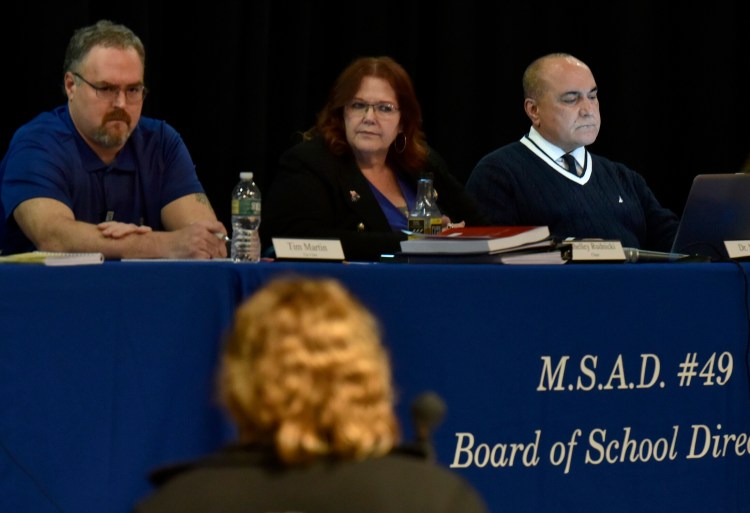 SAD 49 teacher Diana Nutting addresses from left, SAD 49 school board member Tim Martin, chairwoman Shelley Rudnicki and Superintendent Reza Namin during a well attended meeting with students, faculty and parents in Fairfield on Thursday.