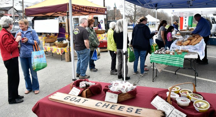 Customers shop for goods Thursday at the new summer location of the Downtown Waterville Farmers Market, at Head of Falls in Waterville. The market, open 2 to 6 p.m., will continue every Thursday rain or shine until the Thursday before Thanksgiving.