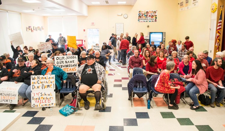 Supporters of the "Indians" nickname wear black on the left, and those in favor of removing it wear red on the right as they wait for the beginning of a school board meeting in April on a proposed nonbinding referendum about whether to retire the name in Skowhegan.