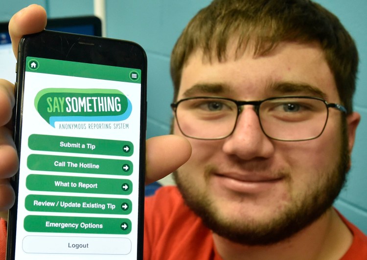 Mid-Maine Technical Center student Lucas Pellotte displays his cellphone Tuesday with the "Say Something" login that can be used to notify officials if a threat is made that is either witnessed or seen online.