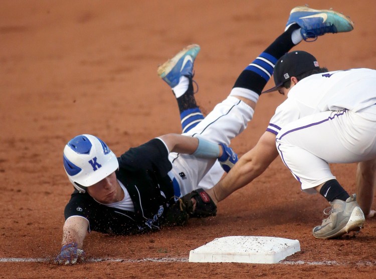 Kennebunk’s Nick Teguis in tagged out at third base by Deering’s Michael Randall during Kennebunk’s 20-2 victory on Tuesday night at Hadlock Field.