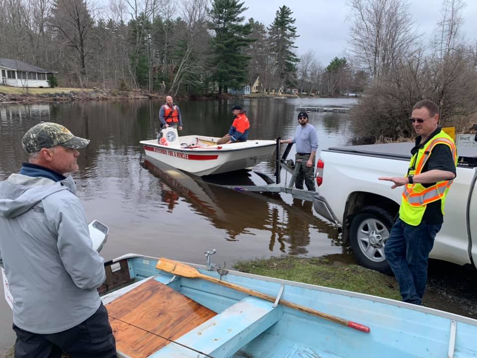 David Reiss, left, stands with members of Jefferson Fire and Rescue after he saved a man whose boat had capsized Monday in Damariscotta Lake.