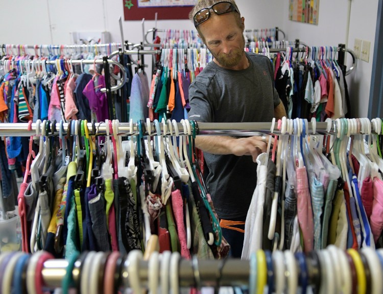 Joseph McKenna shops for clothing July 26 at Bridging the Gap, an Augusta nonprofit organization that oversees Addie's Attic clothing bank, Everyday Essentials toiletries pantry and, in the winter, Augusta Community Warming Center.