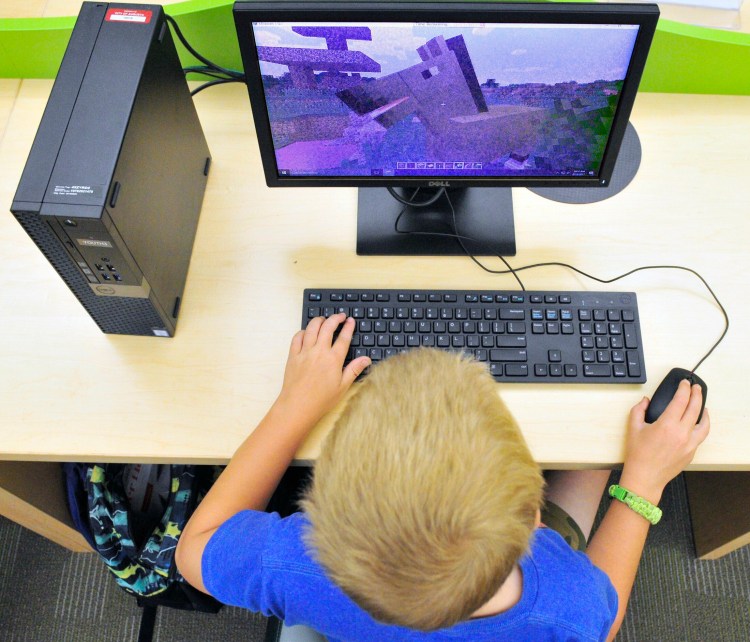 Wesley Jordan plays Minecraft on a computer in the children's area of the Lithgow Public Library on Aug. 18, 2017 in Augusta. A computer virus shut down computer systems throughout city operations two weeks ago, including at Lithgow.