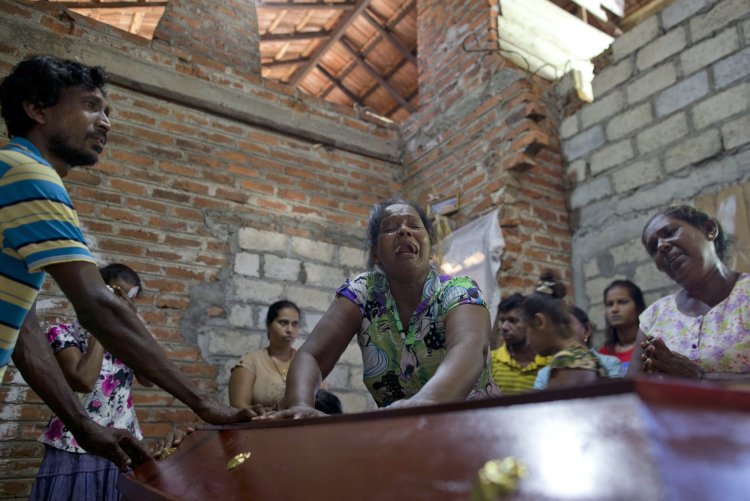 Lalitha, center, weeps over the coffin with the remains of her 12-year old niece, Sneha Savindi, who was a victim of the Easter Sunday bombing at St. Sebastian Church. The bombings of churches, luxury hotels and other sites was Sri Lanka's deadliest violence since a devastating civil war in the South Asian island nation ended a decade ago. 