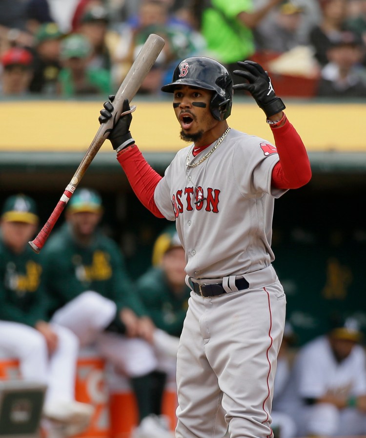 Mookie Betts shows his disbelief after taking a called third strike Thursday against the Oakland Athletics. Betts also was thrown out on the bases and was involved in an outfield misplay, and Boston lost, 7-3.