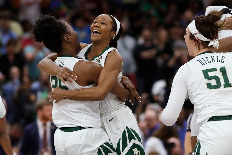 Chloe Jackson jumps into the arms of Queen Egbo after Baylor held on to beat Notre Dame, 82-81, to win the NCAA Division I title on Sunday in Tampa, Fla.