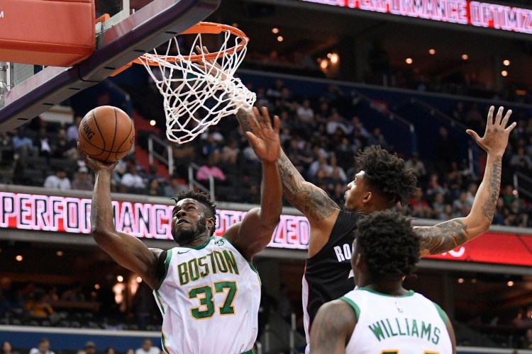 Boston Celtics forward Semi Ojeleye (37) goes to the basket against Washington Wizards forward Devin Robinson, back right, during the first half of an NBA basketball game, Tuesday, April 9, 2019, in Washington. Celtics center Robert Williams III is at bottom right. (AP Photo/Nick Wass)