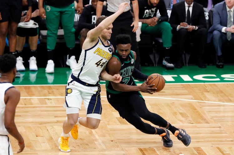 Boston's Jaylen Brown drives on the Pacers' Bojan Bogdanovic Sunday during Game 1 of their first-round playoff series at TD Garden. The Celtics won, 84-74.