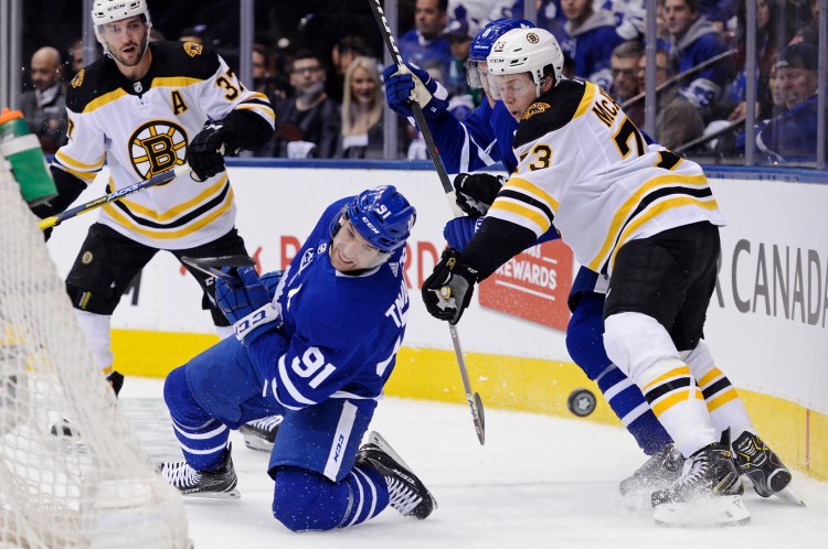Boston Bruins defenseman Charlie McAvoy takes down Toronto Maple Leafs center John Tavares during Game 3 of their first-round playoff series on Monday in Toronto. The Maple Leafs won 3-2 to take a 2-1 series lead.