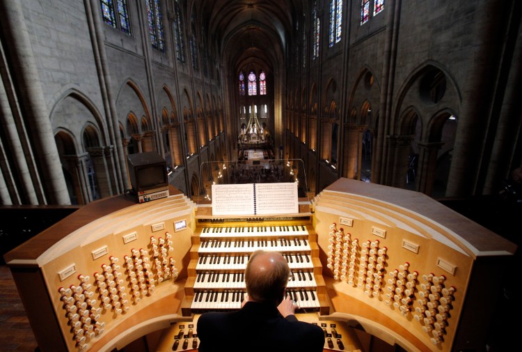 Philippe Lefebvre plays the organ at Notre Dame cathedral in Paris in 2013. The organ didn't burn in the fire, but it isn't yet known whether it was damaged.