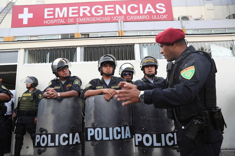 Peru's police officers stand guard at the emergency hospital Casimiro Ulloa where former Peruvian President Alan Garcia was taken after he shot himself in his neck, in Lima, Peru, Wednesday, April 17, 2019.   Garcia shot himself before being detained by police.  