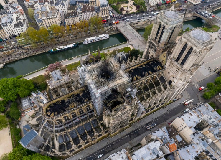 An aerial photo shows fire damage to Notre Dame cathedral in Paris on Tuesday. Nearly $1 billion has already poured in from ordinary worshippers and high-powered magnates around the world to restore Notre Dame Cathedral in Paris after it was damaged in a massive fire on Monday. 