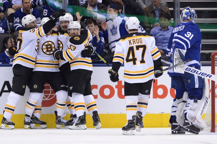 Bruins right wing David Pastrnak, second left, celebrates his goal against Maple Leafs goaltender Frederik Andersen during the second period of Game 4 Wednesday night in Toronto.