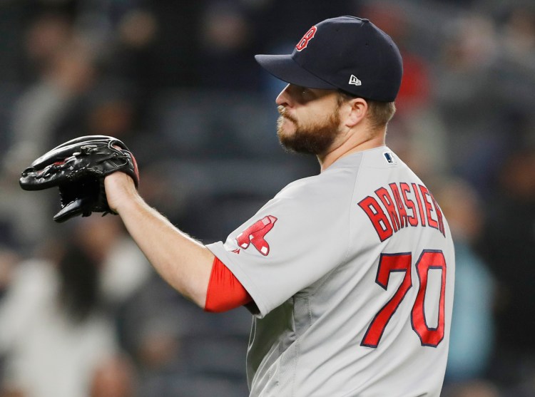 Red Sox reliever Ryan Brasier reacts after allowing a seventh-inning, grand slam to New York's Brett Gardner.