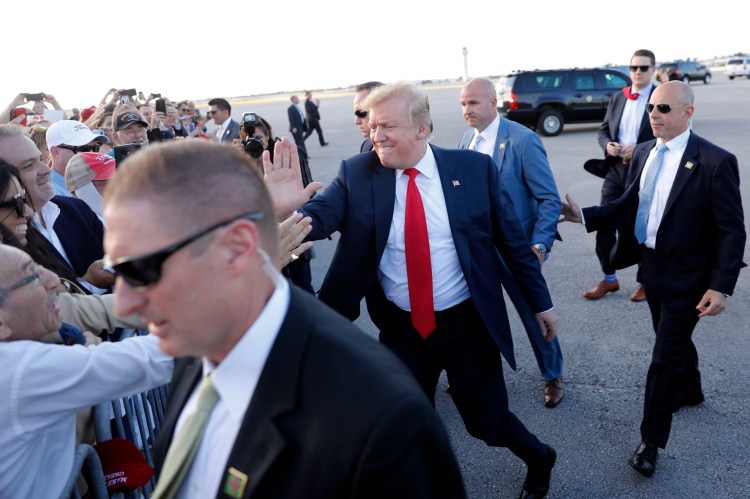 President Trump greets people at Palm Beach International Airport on Thursday in West Palm Beach, Fla. Trump is spending the Easter weekend as his Mar-a-Lago estate. 