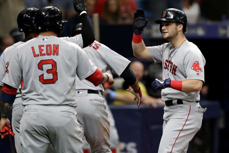 Andrew Benintendi, right, is congratulated by teammates after hitting a grand slam in the second inning Saturday against the Tampa Bay Rays. Benintendi finished with five RBI in Boston's 6-5 win.