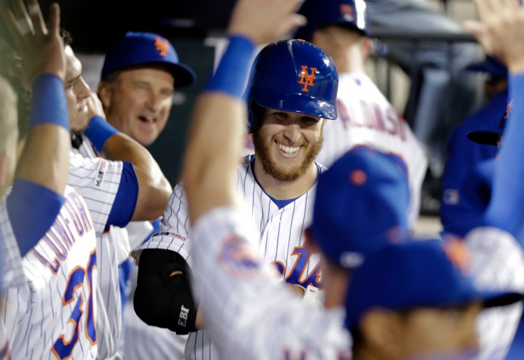 Mets starting pitcher Zack Wheeler is congratulated after hitting his first major league home run in New York's 9-0 win over Philadelphia on Tuesday in New York.