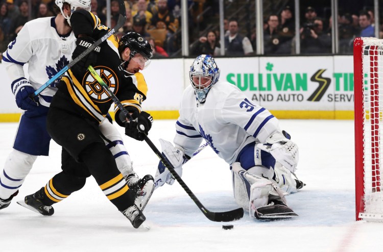 Bruins left wing Brad Marchand, left, tries unsuccessfully to shoot past Maple Leafs goaltender Frederik Andersen Tuesday night in Game 7. The Bruins won to advance to the second round. Game 1 vs. Columbus is Thursday night at Boston.
